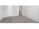 Bedroom features soft carpeting, neutral walls, and two doors at 98 Longhorn Way, Auburn, GA 30011