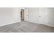 Bedroom features soft carpeting, neutral walls, and two doors at 98 Longhorn Way, Auburn, GA 30011