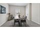 Modern dining room with wood table, seating for six, neutral decor, and carpet flooring at 98 Longhorn Way, Auburn, GA 30011