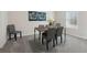 Dining room with wood table, seating for six, neutral decor, and carpet flooring at 98 Longhorn Way, Auburn, GA 30011