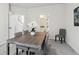 Dining room featuring wood table, seating for six, neutral decor, and carpet flooring at 98 Longhorn Way, Auburn, GA 30011