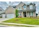 Attractive two-story home with well-maintained lawn, three-car garage, and brick and siding accents at 98 Longhorn Way, Auburn, GA 30011
