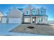 Charming two-story home with gray brick, a two-car garage, manicured lawn and covered entryway at 98 Longhorn Way, Auburn, GA 30011