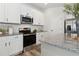 Bright kitchen featuring white cabinets, granite countertops and stainless steel appliances at 98 Longhorn Way, Auburn, GA 30011