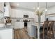 Modern kitchen featuring white cabinetry, stainless steel appliances, and a center island with granite countertops at 98 Longhorn Way, Auburn, GA 30011