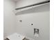 Bright laundry room featuring a wire shelf and utility connections at 98 Longhorn Way, Auburn, GA 30011