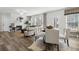 Open-concept living room with fireplace, dining area, and natural light at 98 Longhorn Way, Auburn, GA 30011