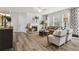 Spacious living room with a fireplace, comfortable seating, and hardwood flooring at 98 Longhorn Way, Auburn, GA 30011