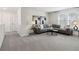 Neutral colored living room with carpet and ample seating around a center table at 98 Longhorn Way, Auburn, GA 30011