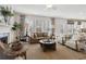 Inviting living room with a cozy fireplace, plush seating, and large windows for natural light at 98 Longhorn Way, Auburn, GA 30011