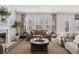 Comfortable living room featuring a fireplace, sofa, chairs, and ample natural light at 98 Longhorn Way, Auburn, GA 30011