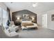 Relaxing main bedroom features stylish lamps and a cozy bench at the foot of the bed at 98 Longhorn Way, Auburn, GA 30011
