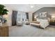 Spacious main bedroom features a ceiling fan, decorative bedside lamps, and luxurious gray decor at 98 Longhorn Way, Auburn, GA 30011