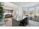 Bright home office area featuring a large desk, sitting area, and views from large windows at 98 Longhorn Way, Auburn, GA 30011