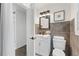 Modern bathroom with dark floors and tiled walls, plus a white vanity and toilet at 1350 Redford Se Dr, Atlanta, GA 30315