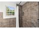 Bathroom features tiled shower, hexagon tiled floor, and bright window at 1350 Redford Se Dr, Atlanta, GA 30315