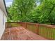 A spacious wooden deck surrounded by lush trees and greenery at 1350 Redford Se Dr, Atlanta, GA 30315