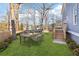Landscaped backyard with a dining table set, a swing, and stairs leading to the deck at 1977 Nash Se Ave, Atlanta, GA 30316
