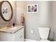 Stylish bathroom with a granite vanity, round mirror, and modern fixtures at 1977 Nash Se Ave, Atlanta, GA 30316