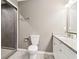 Well-lit bathroom featuring granite countertops, a shower, and grey tile flooring at 1977 Nash Se Ave, Atlanta, GA 30316