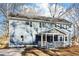Charming two-story home with a welcoming front porch and blue siding, nestled among mature trees at 1977 Nash Se Ave, Atlanta, GA 30316