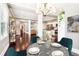 Open-concept living space with elegant dining table, modern lighting, and view into the kitchen at 1977 Nash Se Ave, Atlanta, GA 30316