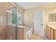 A luxurious bathroom with a shower, garden tub, tiled walls, and natural light at 3845 New Salem Ct, Cumming, GA 30040
