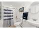 Bright bathroom with a shower, toilet, sink, towel, and a decorative mirror at 3845 New Salem Ct, Cumming, GA 30040