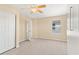 A bright bedroom with a ceiling fan offers ample space and a window view at 3845 New Salem Ct, Cumming, GA 30040