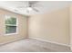 Bedroom featuring neutral carpet, natural light from a window, and a ceiling fan at 3845 New Salem Ct, Cumming, GA 30040