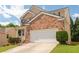 Beautiful brick house featuring a two-car garage and a neatly maintained lawn on a sunny day at 3845 New Salem Ct, Cumming, GA 30040