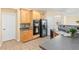 A spacious kitchen featuring stainless steel appliances, a dark countertop and wooden cabinets at 3845 New Salem Ct, Cumming, GA 30040