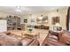 Open-concept living room with hardwood floors, a ceiling fan, and plenty of natural light at 3845 New Salem Ct, Cumming, GA 30040