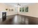 Cozy living room with a fireplace, ceiling fan, and large windows offering great lighting at 3845 New Salem Ct, Cumming, GA 30040