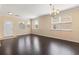 Spacious living room with gleaming hardwood floors and large windows offering ample natural light at 3845 New Salem Ct, Cumming, GA 30040