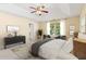 A serene main bedroom features a ceiling fan, tray ceiling, sitting area and natural light at 3845 New Salem Ct, Cumming, GA 30040