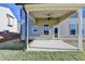 Charming covered patio offers an idyllic view of the expansive backyard at 58 Longhorn Way, Auburn, GA 30011