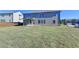 Lush backyard highlighting a covered patio and ample green space at 58 Longhorn Way, Auburn, GA 30011
