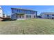 Exterior view highlighting the home's backyard, patio, and meticulous lawn at 58 Longhorn Way, Auburn, GA 30011