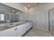 Bright bathroom featuring a double sink vanity with granite countertop and glass shower at 58 Longhorn Way, Auburn, GA 30011