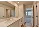 Bathroom with double sink vanity and wood look flooring at 58 Longhorn Way, Auburn, GA 30011