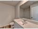 Bright bathroom features a white vanity with a large mirror and tiled floor at 58 Longhorn Way, Auburn, GA 30011