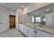 Well-lit bathroom showcasing dual sinks, granite counters, and tile flooring at 58 Longhorn Way, Auburn, GA 30011