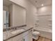 Bathroom featuring a granite countertop, tiled shower/bathtub, and modern fixtures at 58 Longhorn Way, Auburn, GA 30011