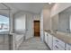 Beautiful bathroom featuring double vanity, tile flooring, walk-in closet access, and tub at 58 Longhorn Way, Auburn, GA 30011