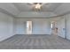 Expansive bedroom with gray carpet, tray ceiling, and various entrances at 58 Longhorn Way, Auburn, GA 30011