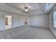 Huge bedroom featuring a tray ceiling, plush carpeting, and two entry doors at 58 Longhorn Way, Auburn, GA 30011