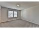 Comfortable bedroom with neutral walls, plush carpeting, and a bright window at 58 Longhorn Way, Auburn, GA 30011
