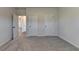 Bedroom showcasing carpeted floors, entry doors, and natural light at 58 Longhorn Way, Auburn, GA 30011