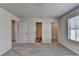 Spacious carpeted bedroom with ensuite bathroom and walk-in closet access at 58 Longhorn Way, Auburn, GA 30011